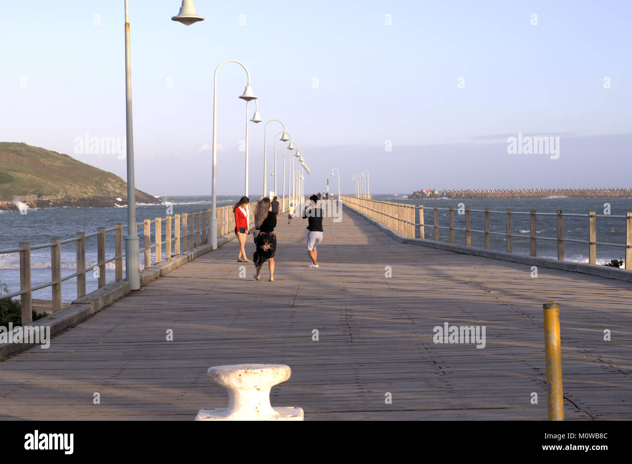 People walking at Jetty Coffs Harbour Australia during golden hour. Coffs Jetty is major Australian holiday destination. Dated 16 Jan 2018. Stock Photo