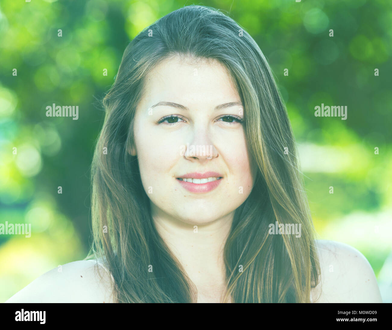 Portrait of smiling female which is sitting on bench in the park Stock ...
