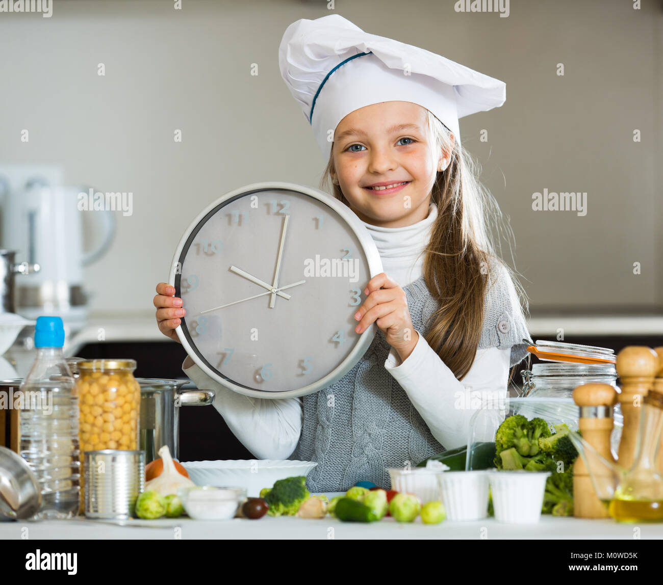 Counting When Cook Portrait of cute little girl counting time down when cooking Stock ...