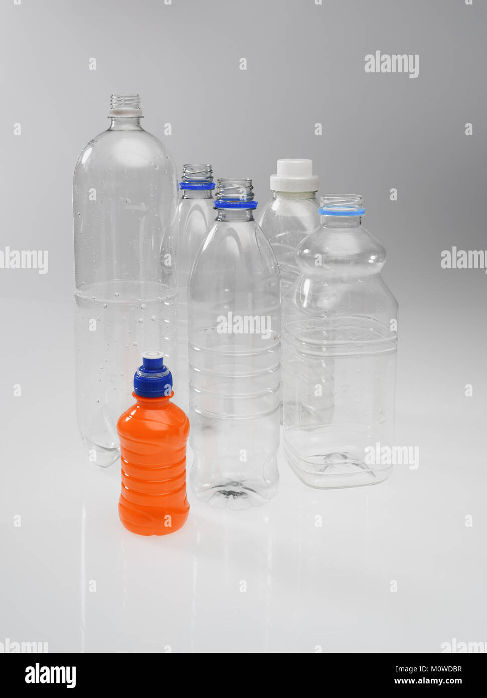 A range of plastic drinking bottles empty and non labelled ready for recycling on white background. Stock Photo