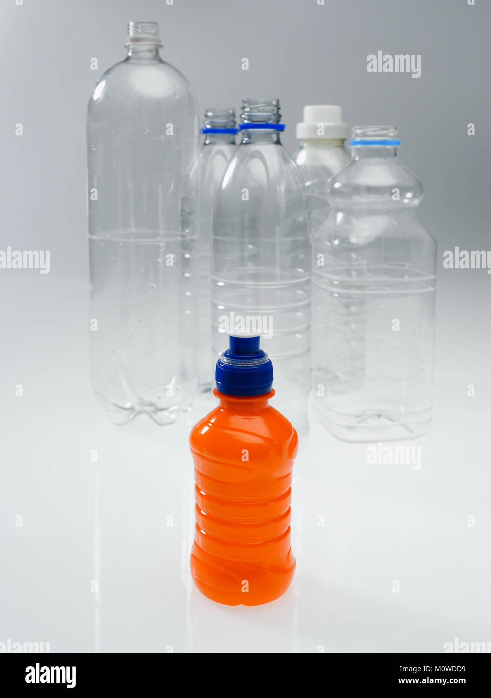 A range of plastic drinking bottles empty and non labelled ready for recycling on white background. Stock Photo