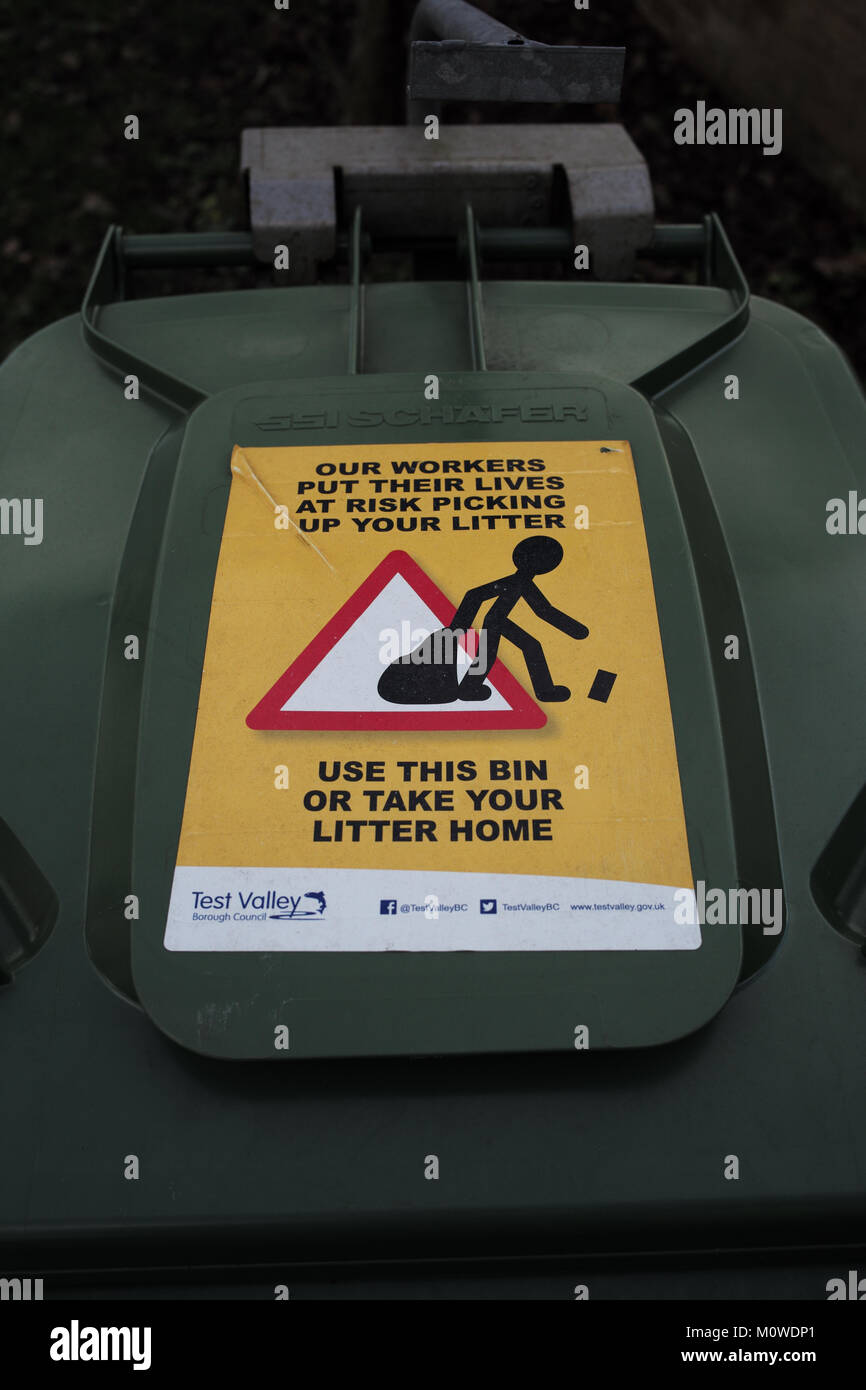 Test Valley council sign stuck to waste bin warning that refuge collectors put their lives at risk picking up litter. Stock Photo