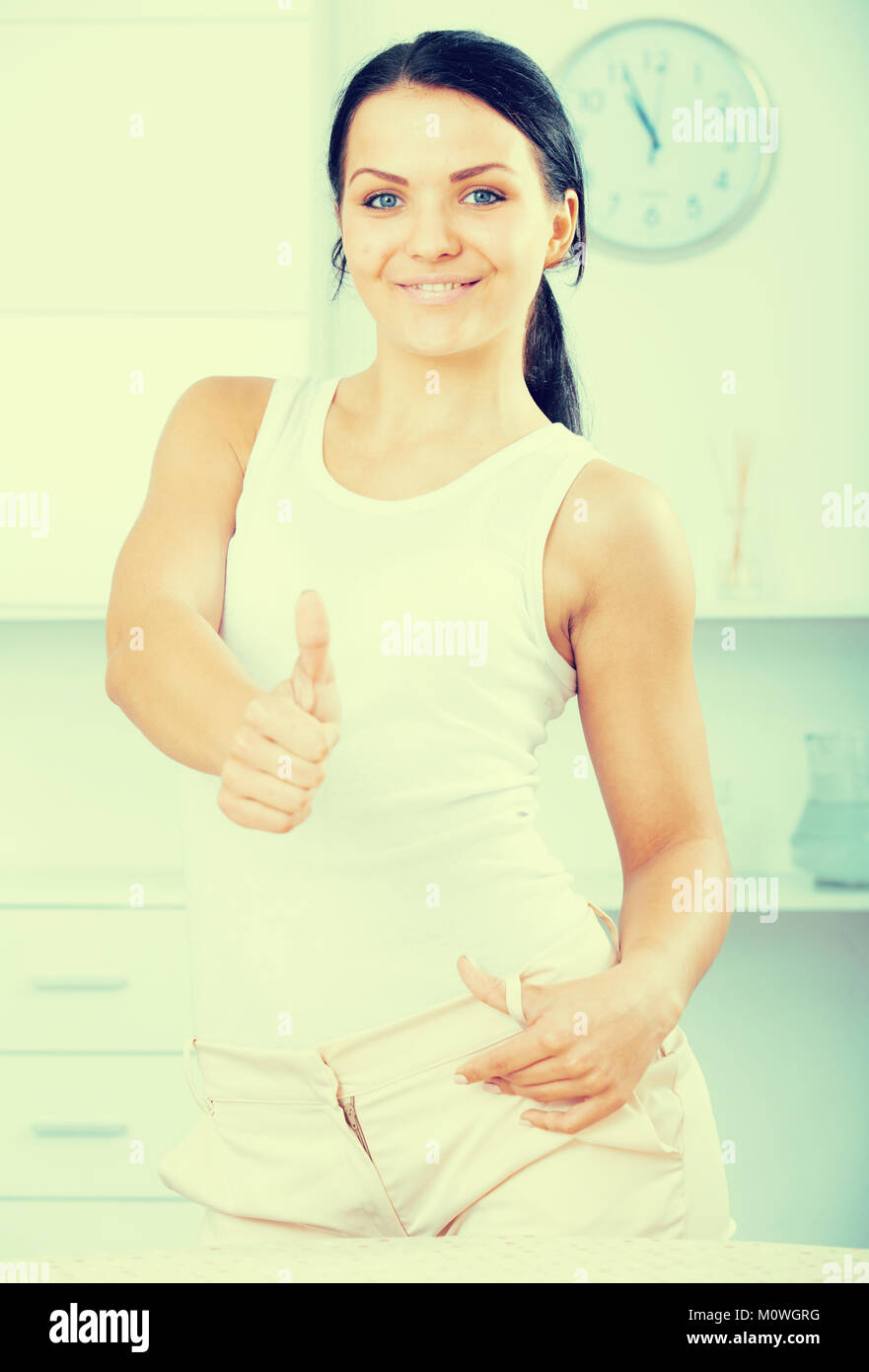Young brunette woman posing and smiling Stock Photo - Alamy