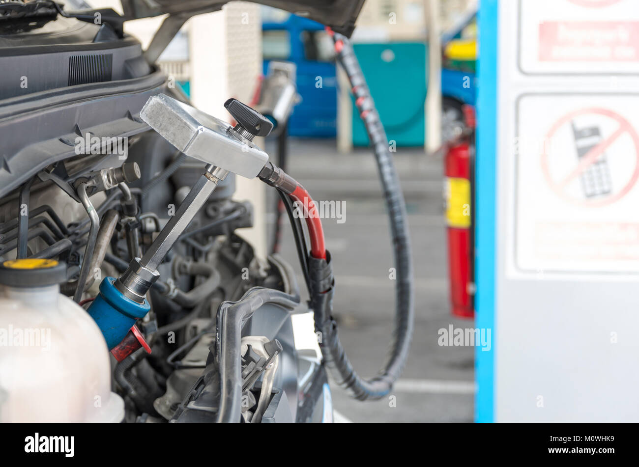 Gas nozzle to add gas in car at gas station Stock Photo Alamy