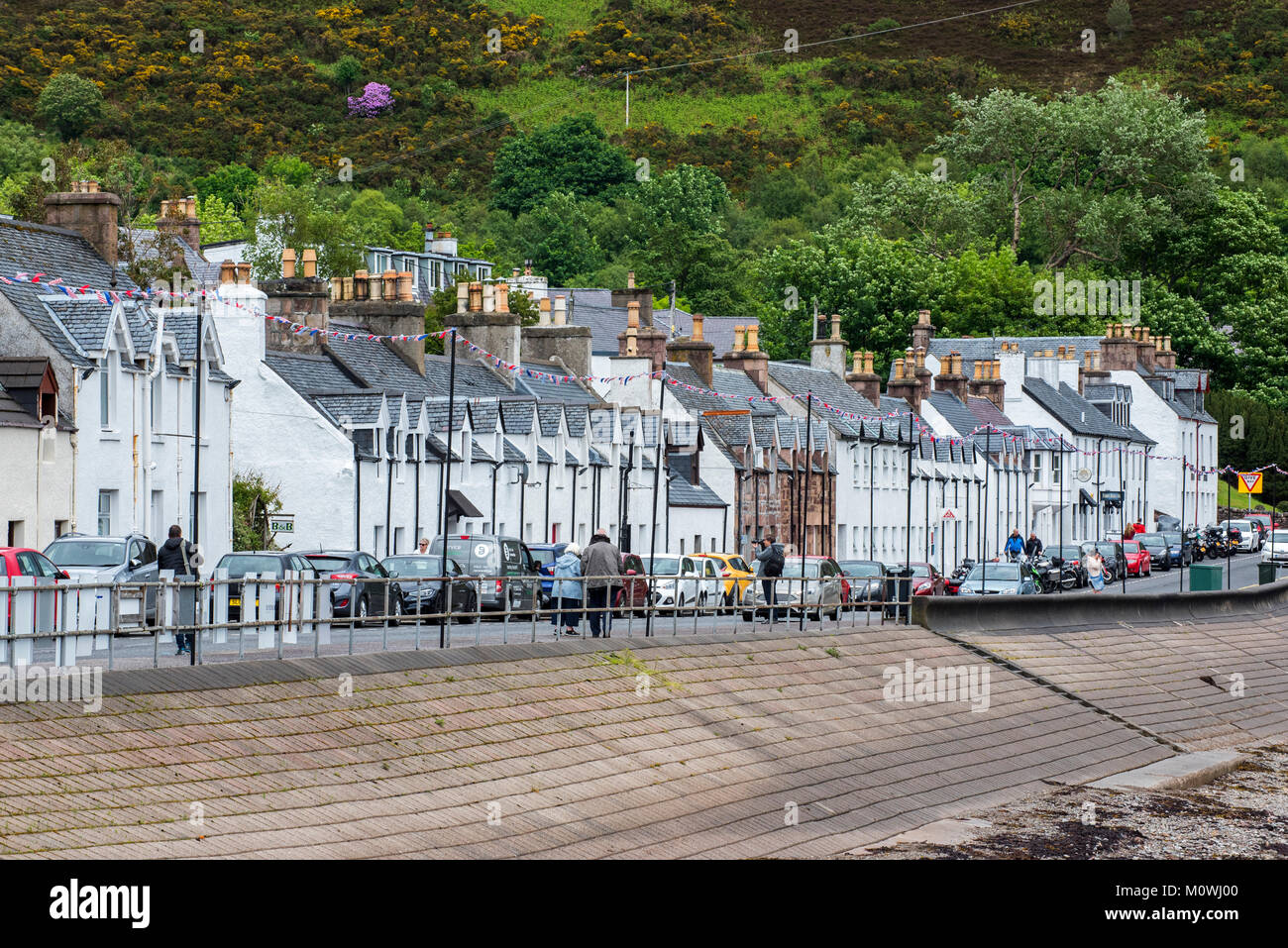 White houses, hotels and pubs in the main street of Ullapool, fishing village in Ross-shire, Scottish Highlands, Scotland, UK Stock Photo