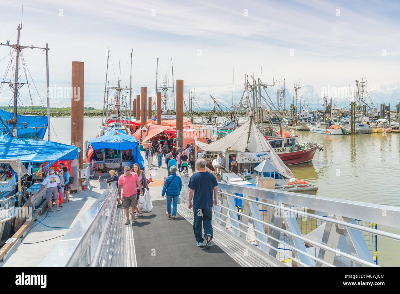 Tourists and locals visit the famous fish market at the Fisherman's Wharf near Richmond, BC, Canada. Stock Photo