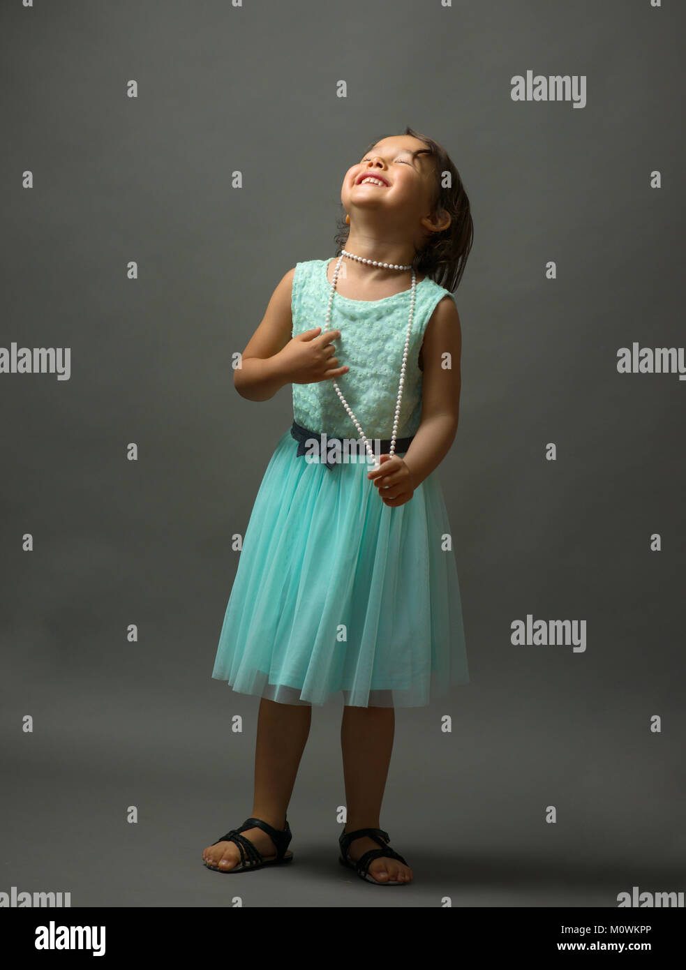 Cute little girl in beautiful dress in studio Stock Photo