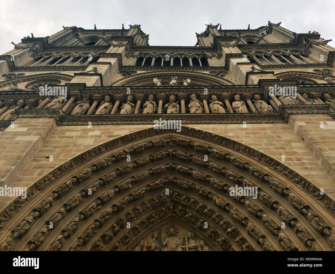 Worms eye view of the front facade of the Notre Dame Cathedral in Paris, France Stock Photo