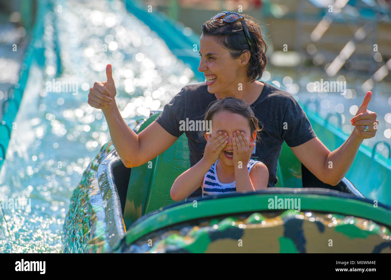 Mother and her daughter having fun in waterpark Stock Photo