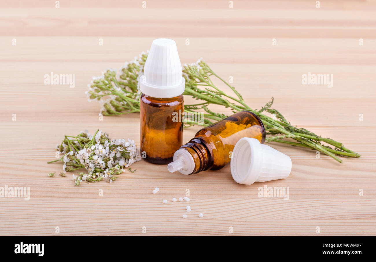 Homeopathic remedy with fresh, flowering yarrow with a wooden background Stock Photo