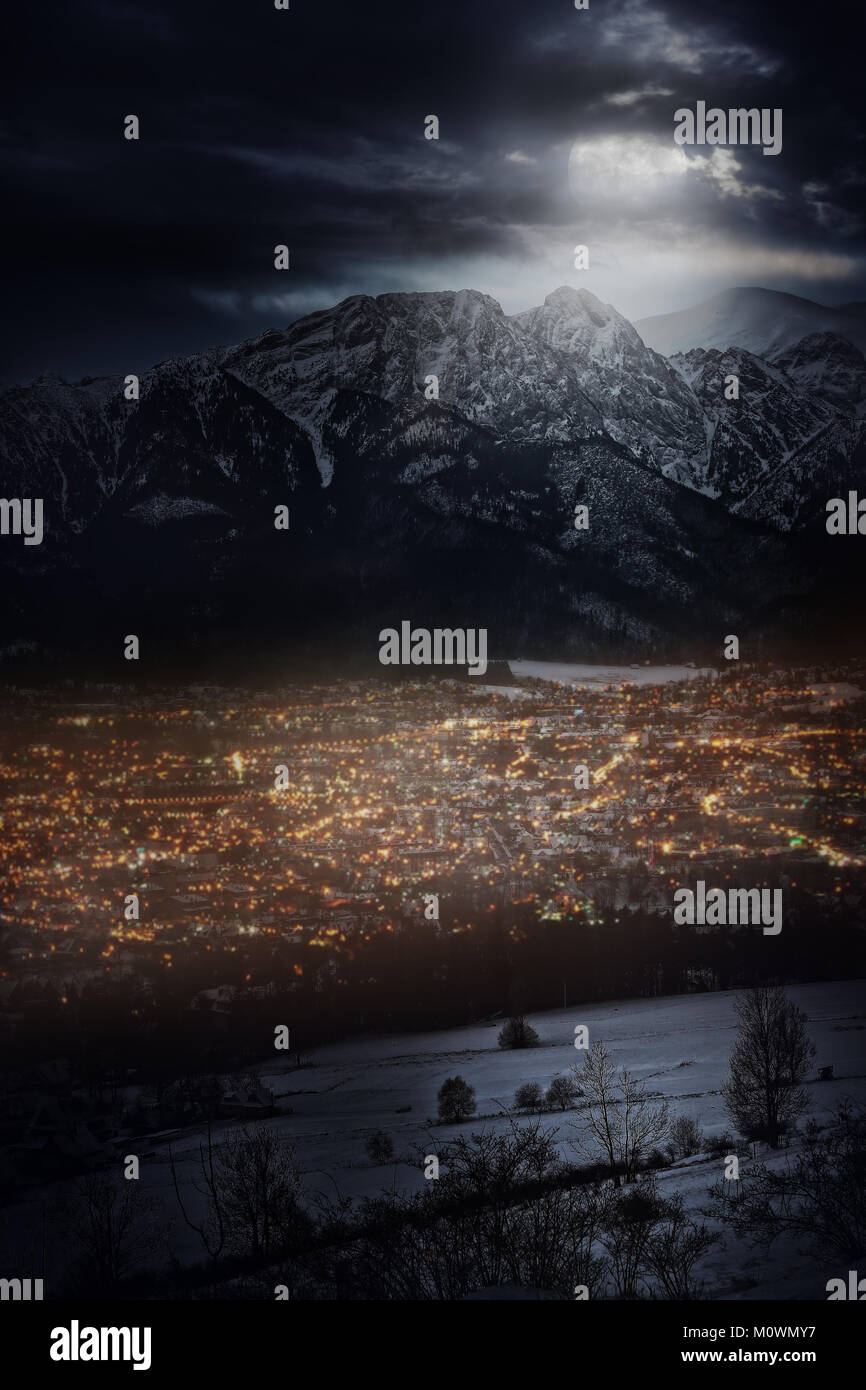 beautiful and moonlit night over a mountain town Stock Photo