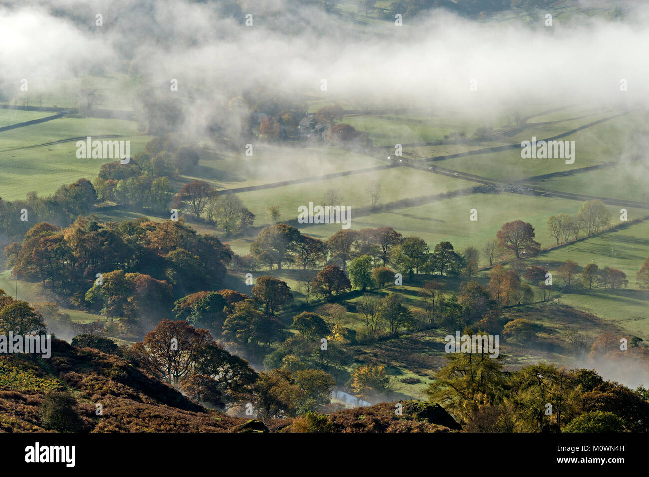 Looking down from above on low level early morning mist in the Patterdale valley in the English Lake District, Cumbria, England, UK Stock Photo