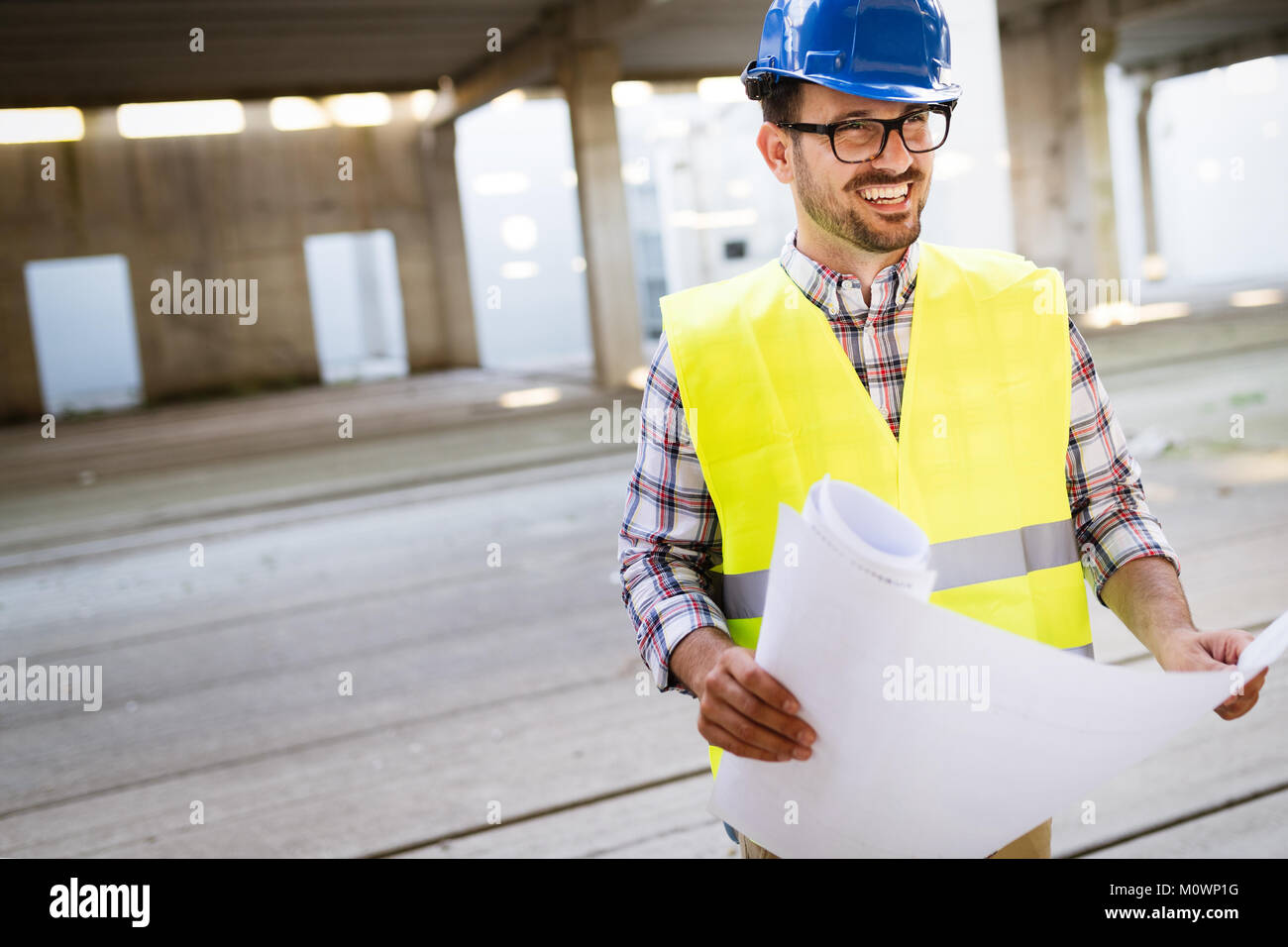 Picture of construction site engineer looking at plan Stock Photo - Alamy