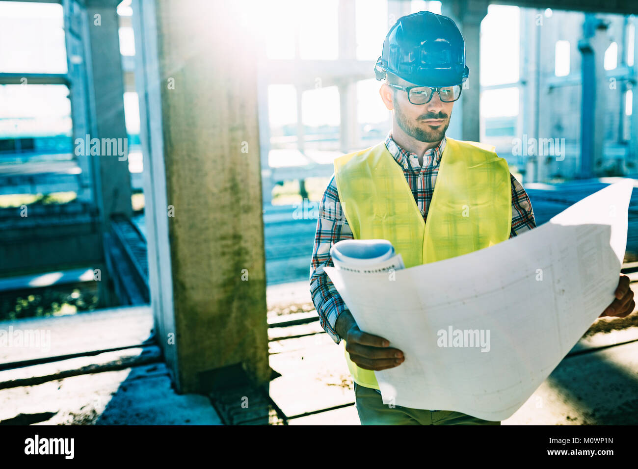 Picture of construction site engineer looking at plan Stock Photo - Alamy