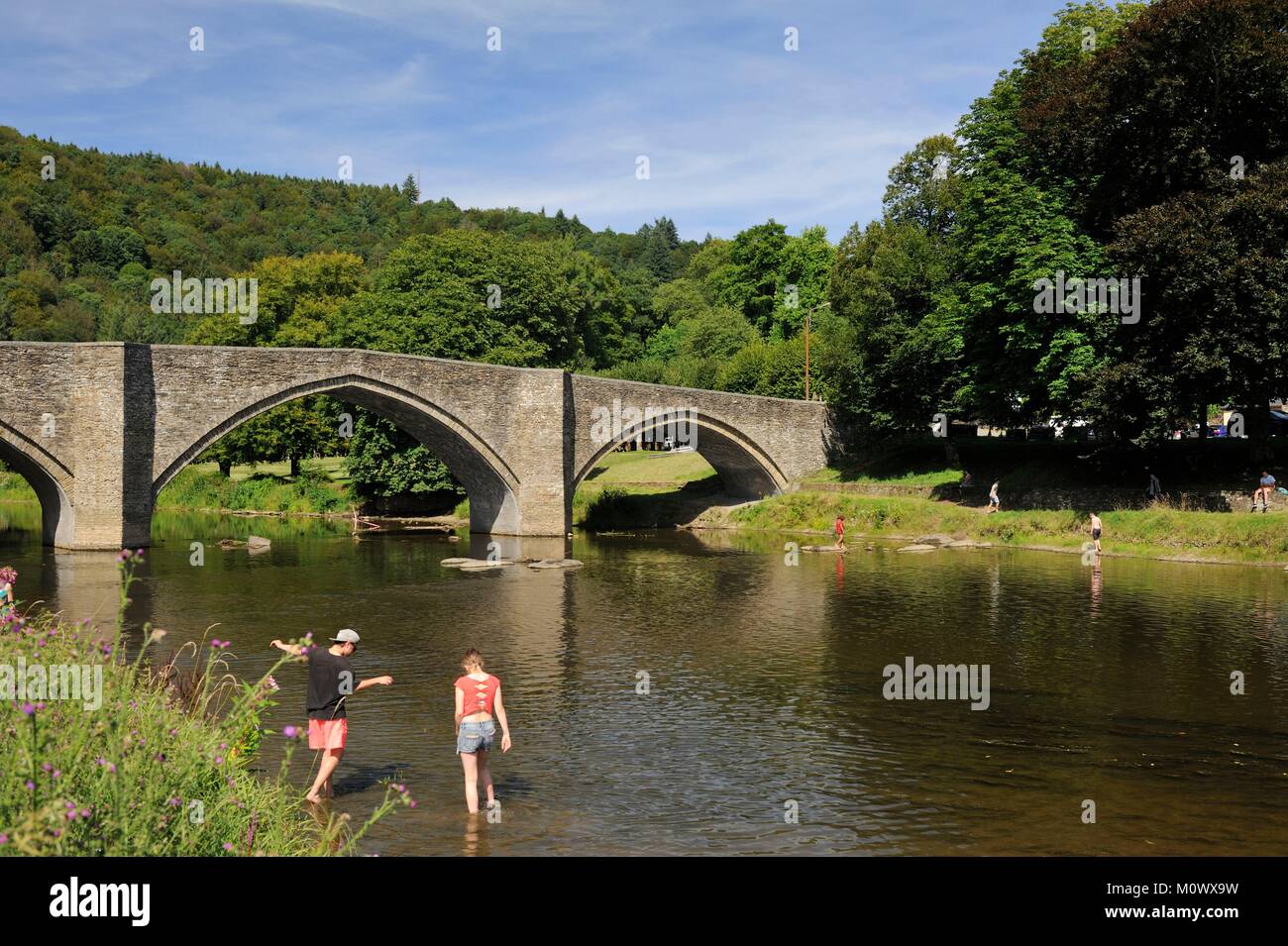 Belgium,Luxembourg,Bouillon,Cordemoy bridge or pulley bridge on the Semois,two people dipping their feet in the water Stock Photo