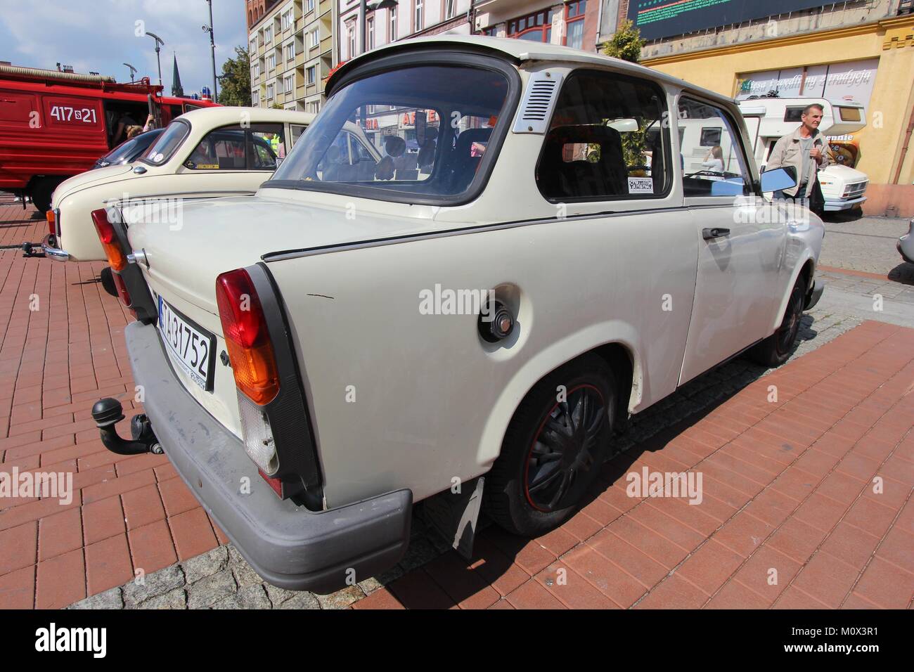 BYTOM, POLAND - SEPTEMBER 12, 2015: People walk by Trabant 601 oldtimer car during 12th Historic Vehicle Rally in Bytom. The annual vehicle parade is  Stock Photo