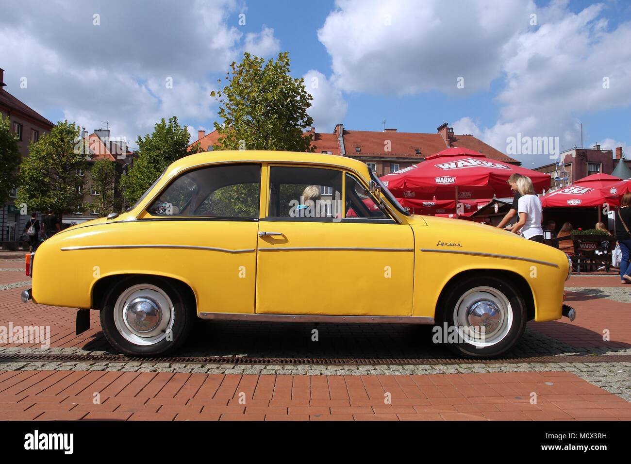 BYTOM, POLAND - SEPTEMBER 12, 2015: People walk by FSO Syrena 105 during 12th Historic Vehicle Rally in Bytom. The annual vehicle parade is one of mai Stock Photo