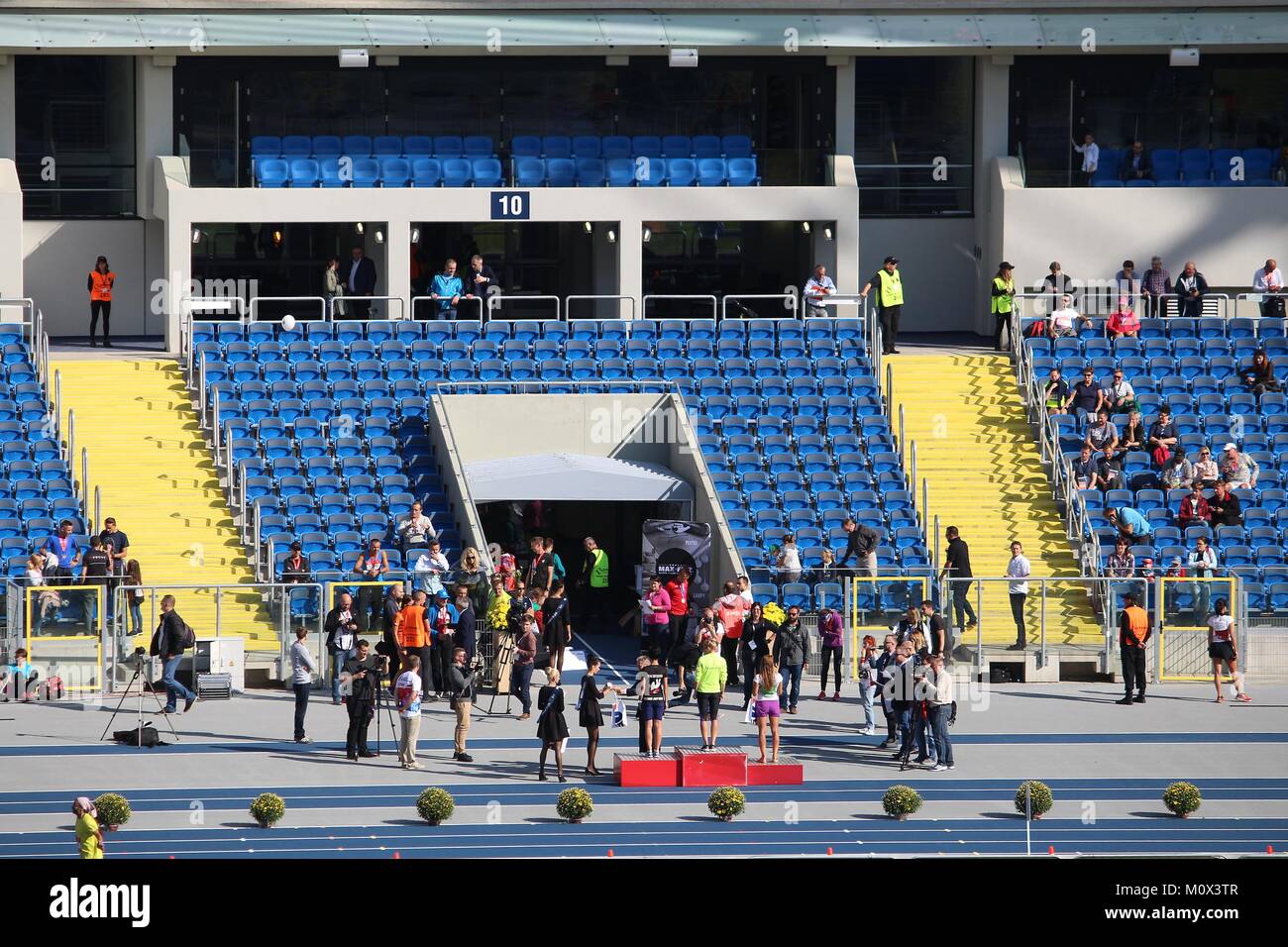 KATOWICE, POLAND - OCTOBER 1, 2017: Runners receive medals in the PKO Silesia Marathon at Silesian Stadium in Katowice, Poland. The marathon had 2,500 Stock Photo