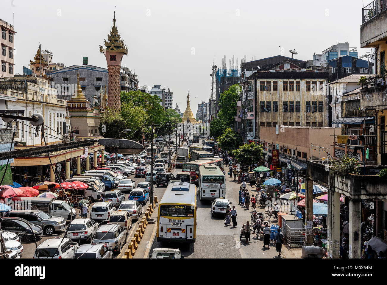 Busy downtown street view in Yangon and Sule Pagoda at the heart of Yangon city, Myanmar Stock Photo