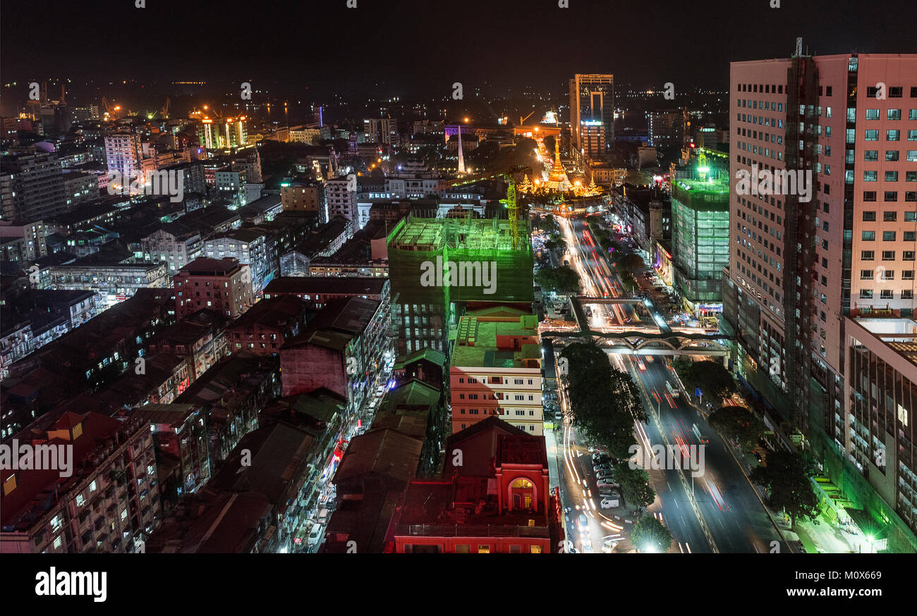 Lighted Sule Pagoda and its surrounding apartments at night, Yangon, Myanmar Stock Photo