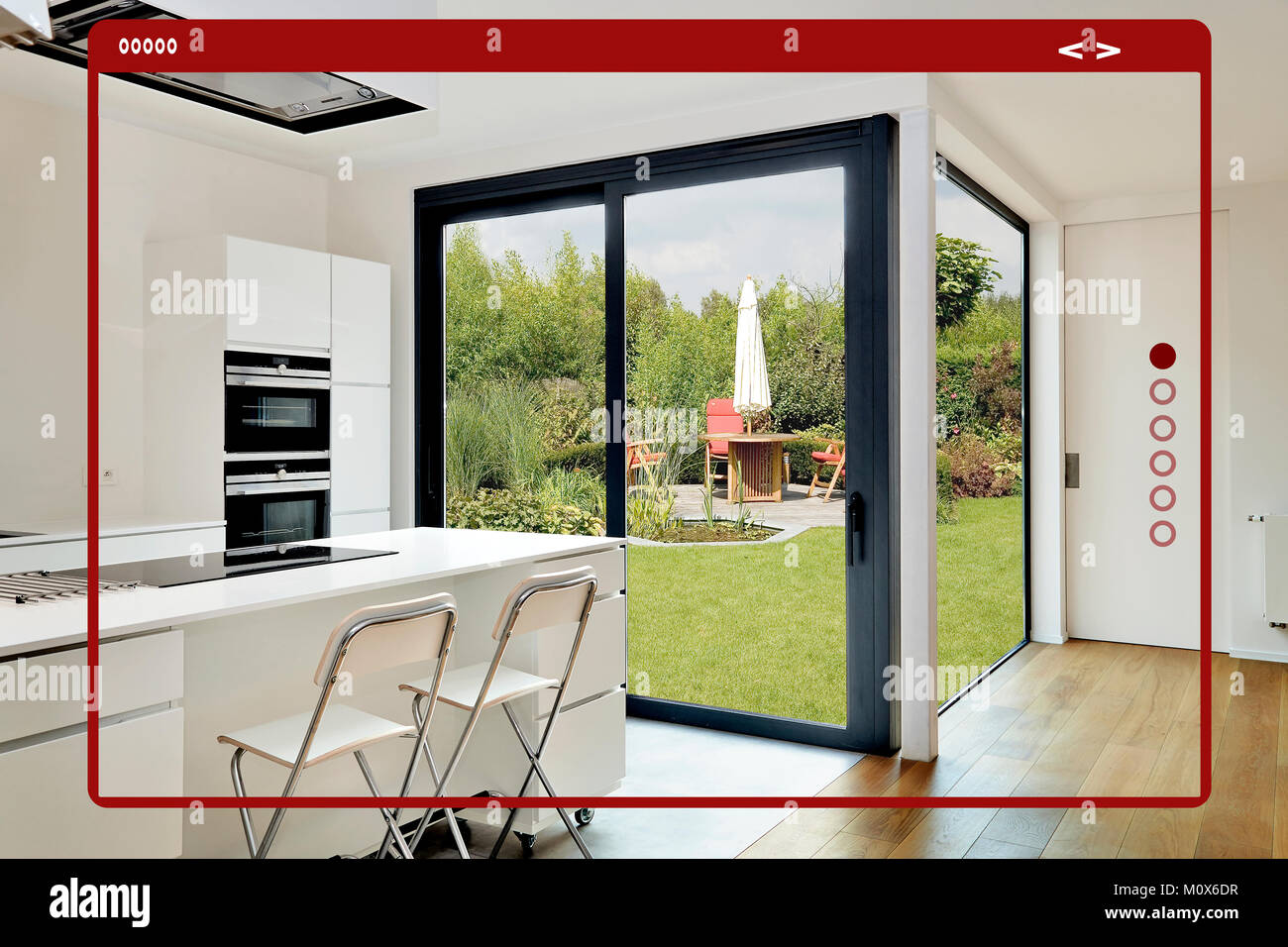 Modern site web interface for gallery.Open modern kitchen from loft with view on a lush garden Stock Photo