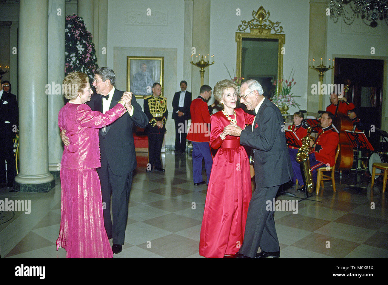 Washington, DC - (FILE) -- United States President Ronald Reagan and Prime Minister Margaret Thatcher of Great Britain share a dance in the Entrance Hall of the the White House in Washington, D.C. following the dinner in her honor on Wednesday, November 16, 1988.  At right their spouses, first lady Nancy Reagan and Denis Thatcher share a dance as well..Credit: Ron Sachs / CNP/ MediaPunch Stock Photo