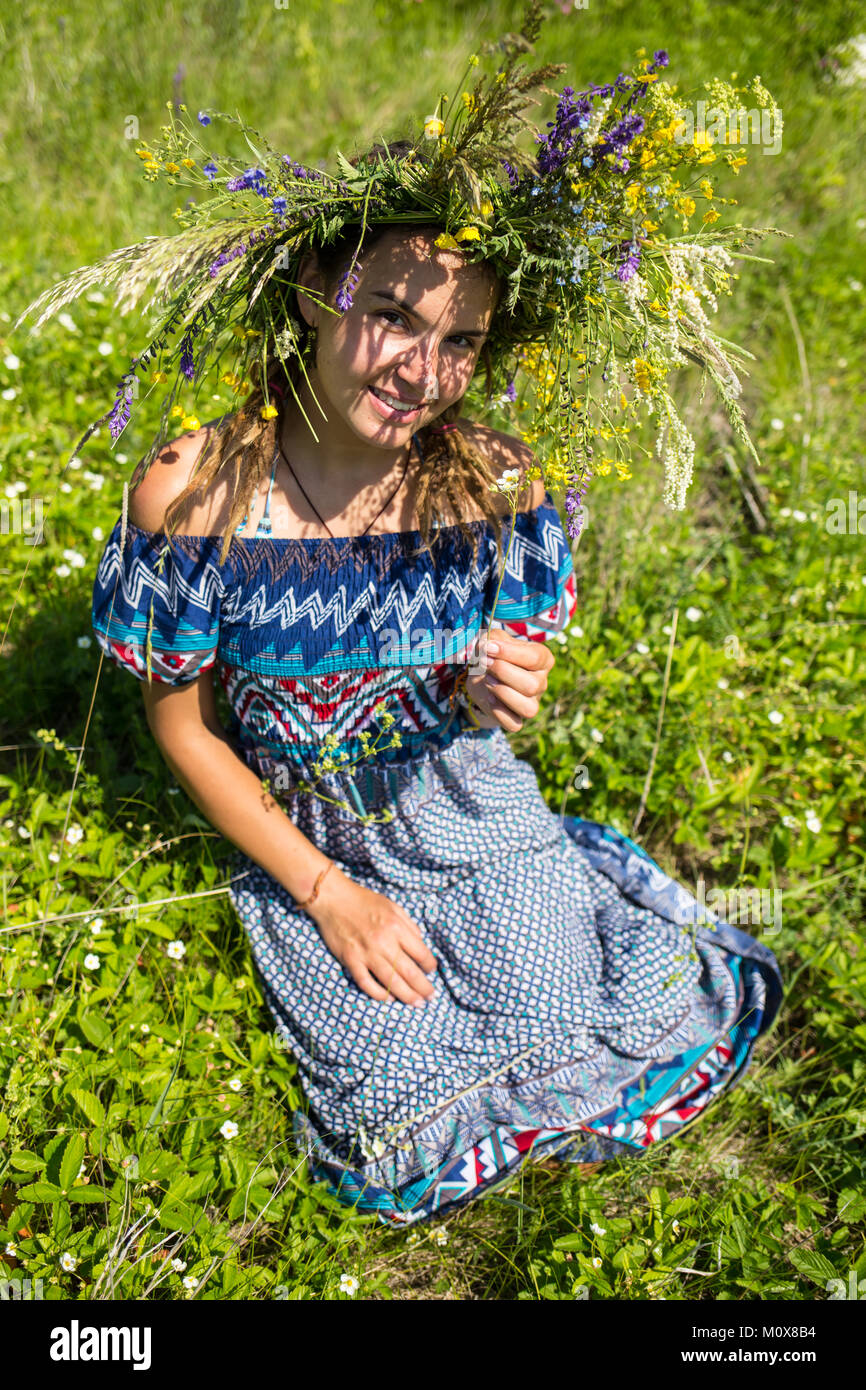 Beautiful young girl with curly red hair in chamomile field Stock Photo ...