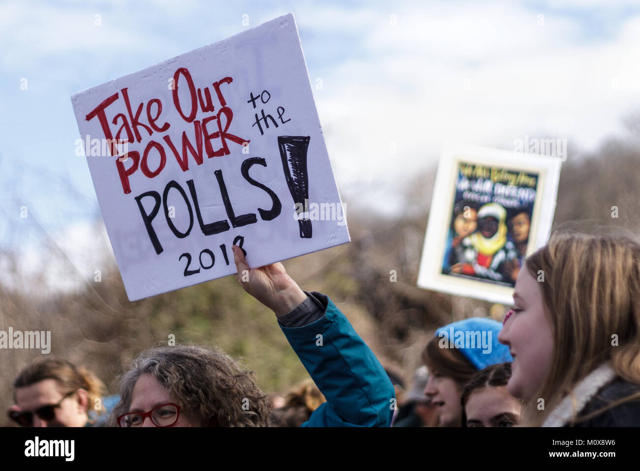 A woman holds up a sigh that says 'Take our power to the polls! 2018' at the Women's March Stock Photo