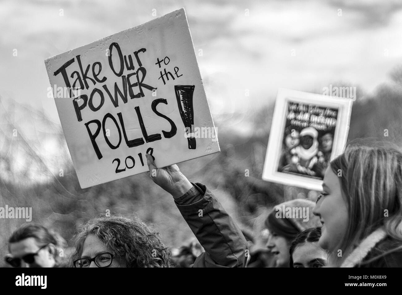 A woman holds up a sigh that says 'Take our power to the polls! 2018' at the Women's March Stock Photo