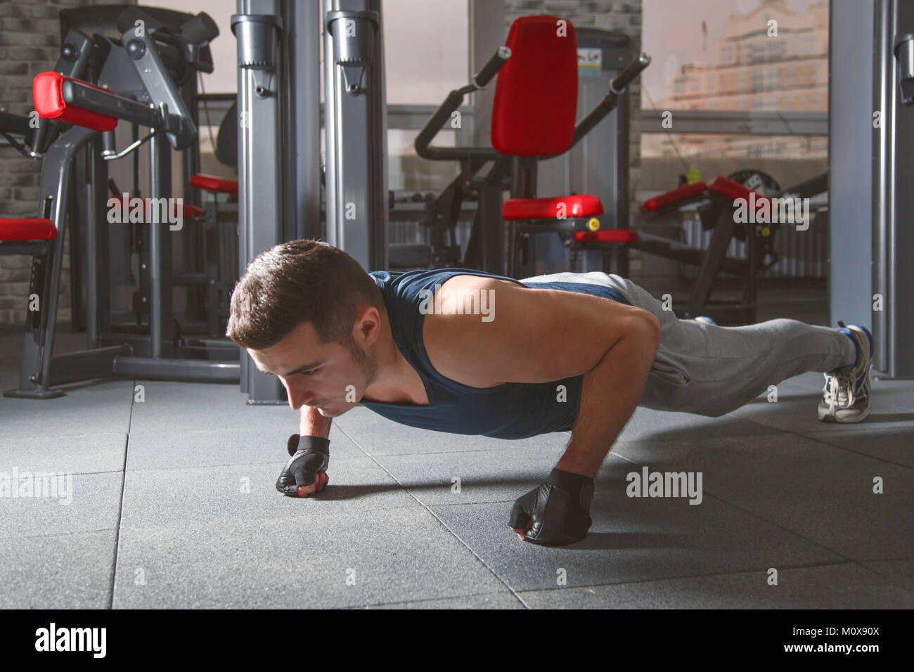 Sport. Young athletic man doing push-ups Stock Photo