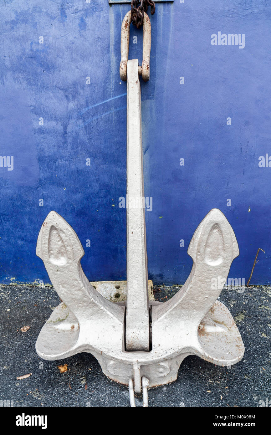 Large anchor leaning of a wall. Stock Photo