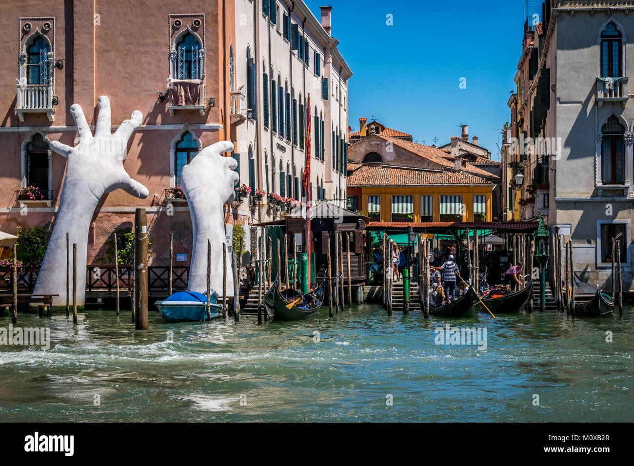Artwork titled “Support” emerges from Grand Canal, by Lorenzo Quinn. The contemporary sculpture of giant hands, 2017 Venice Biennale. Stock Photo