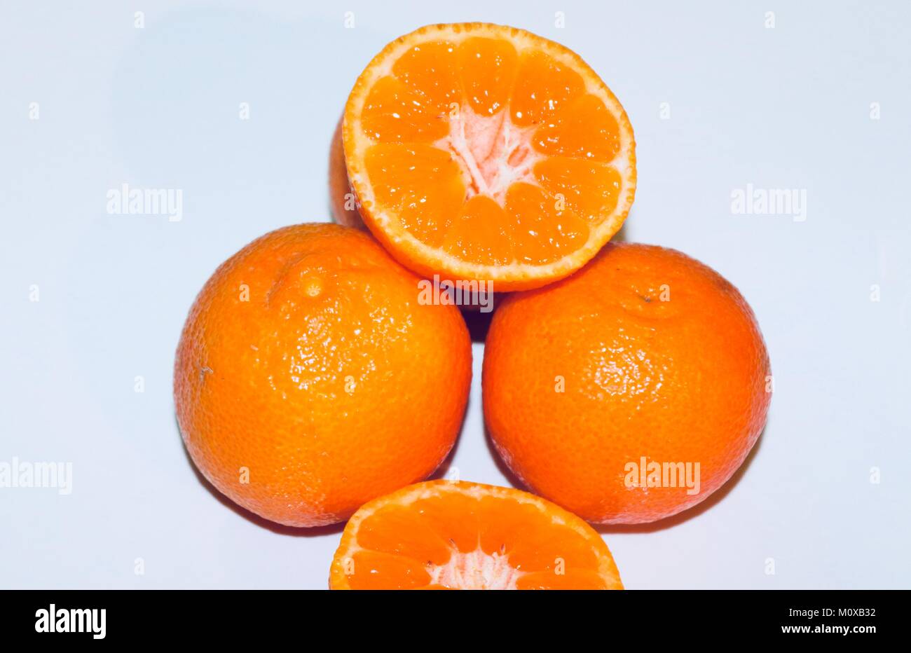 Orange tangerine clementine cut in half juicy healthy snack Stock Photo