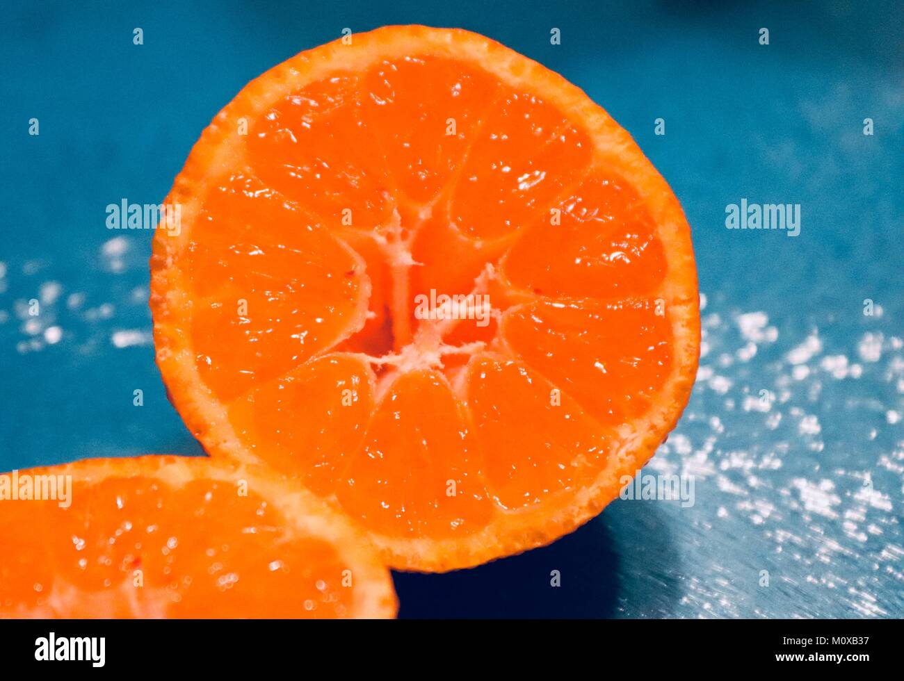 Orange tangerine clementine cut in half juicy healthy snack Stock Photo