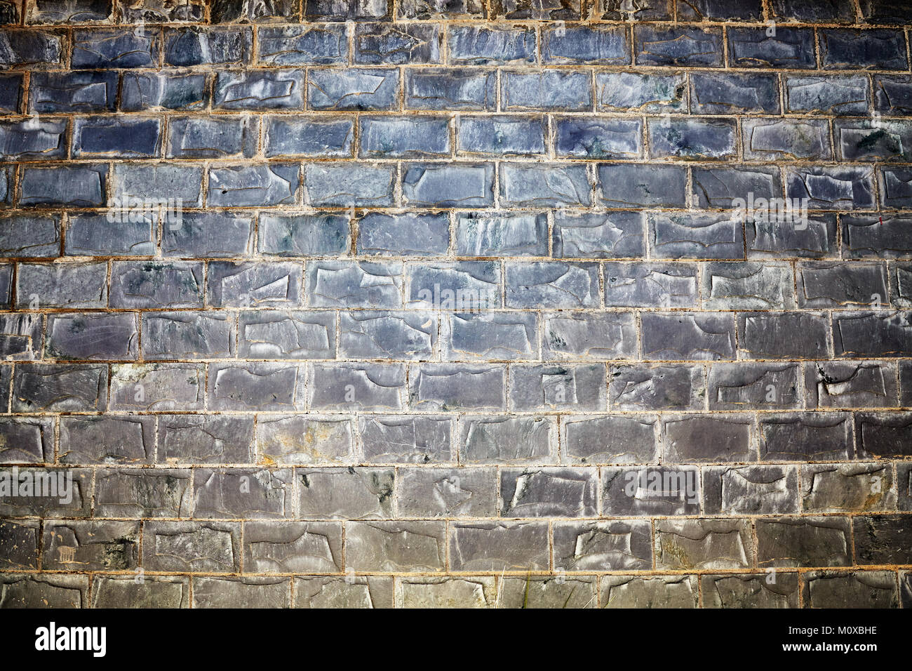 Old stained stone brick wall background or texture. Stock Photo