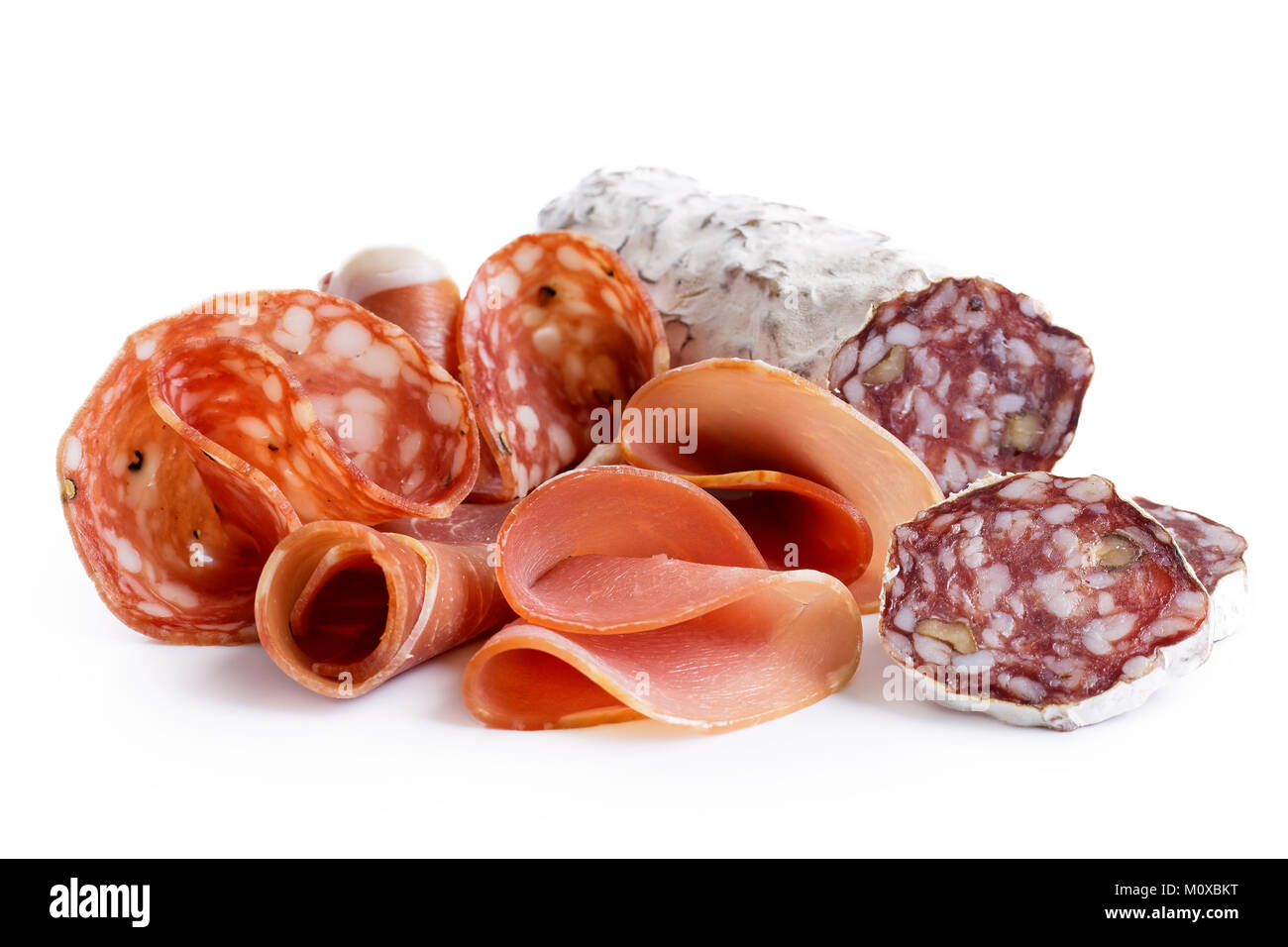 Mixed air cured sliced meats isolated on white. Stock Photo