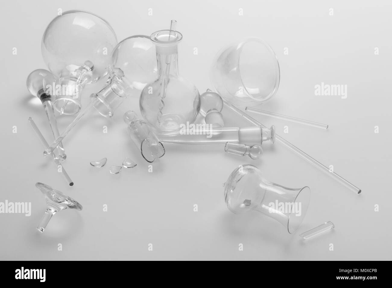 Transparent brittle glass chemical flasks and glassware on a white