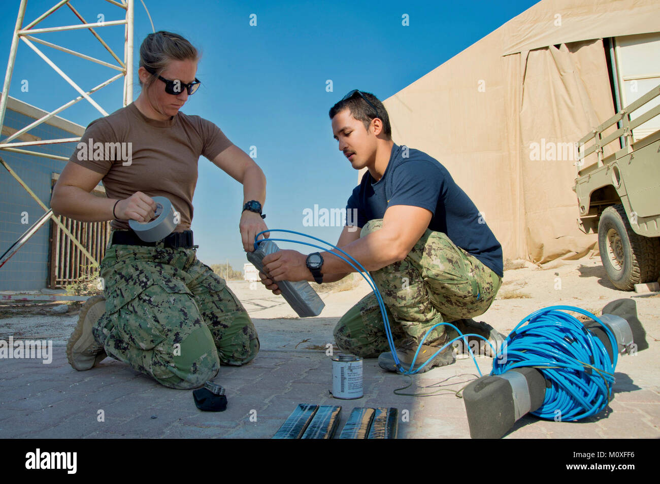 Mohammed Al-Ahmad Naval Base, KUWAIT (Jan. 9, 2018) Explosive Ordnance Disposal Technician 3rd Class Carolyn Willeford, and Explosive Ordnance Disposal Technician 1st Class Jesse Piper, assigned to Commander, Task Group 56.1, build a demolition charge during a training evolution as part of exercise Eager Response 18. Eager Response 18 is a bilateral explosive ordnance disposal military exercise between the State of Kuwait and the United States. The exercise fortifies military-to-military relationships between the Kuwait Naval Force and U.S. Navy, advances the operational capabilities of Kuwait Stock Photo