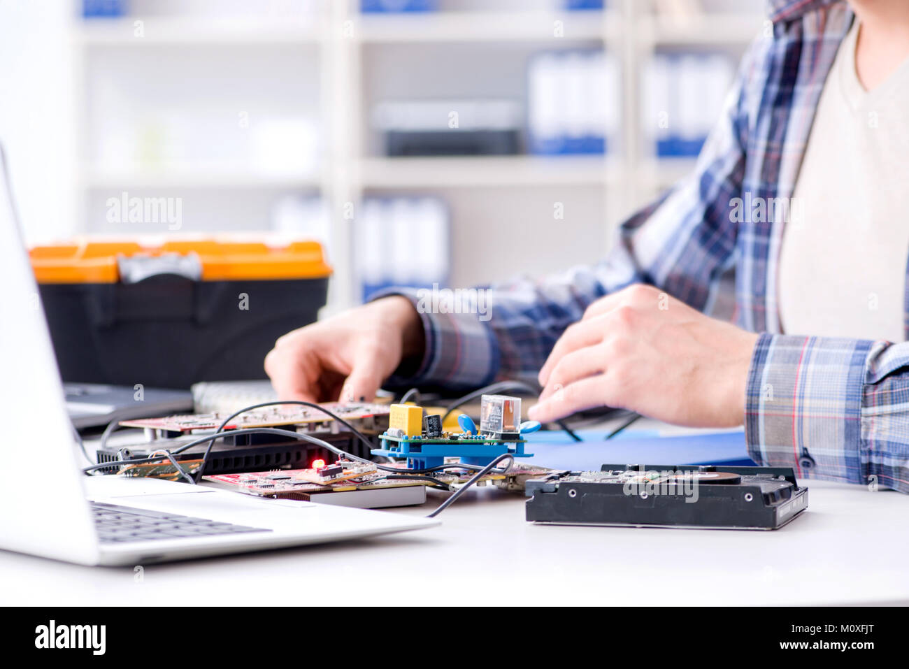 Professional repairman repairing computer in workshop Stock Photo - Alamy