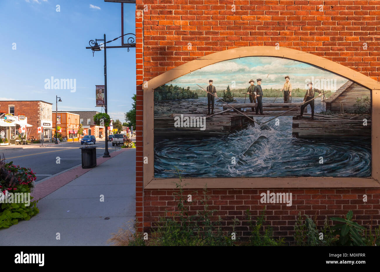 A mural depicting the logging history in Muskoka on the wall of a building in downtown Gravenhurst, Ontario, Canada. Stock Photo