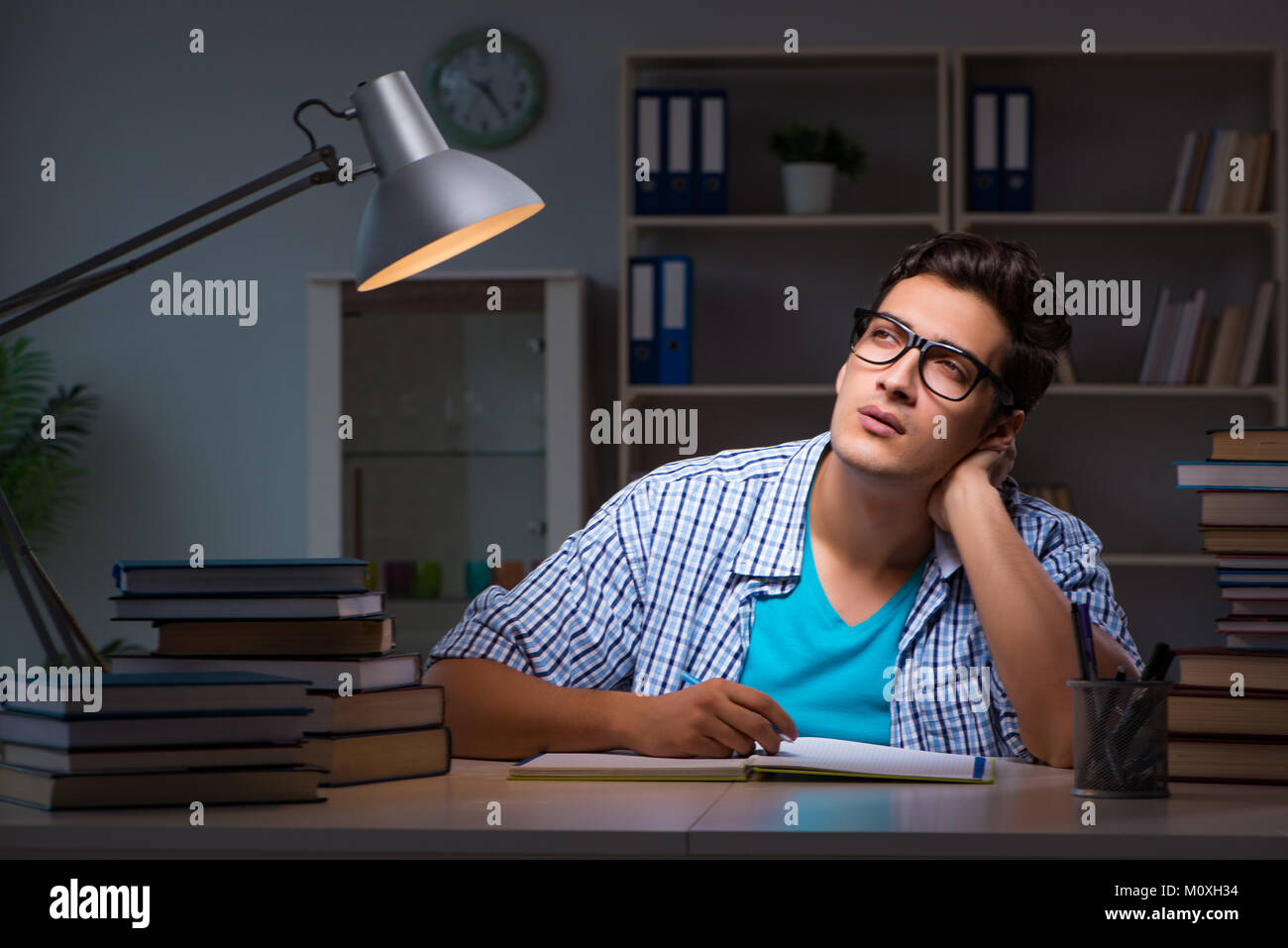 Student preparing for exams late night at home Stock Photo - Alamy