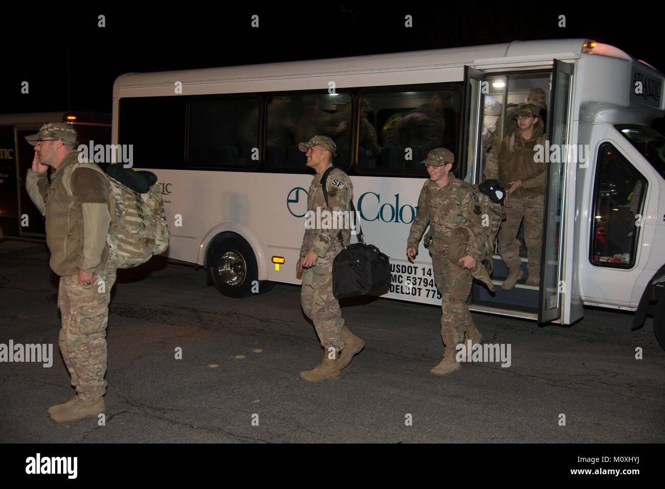 Defenders assigned to the 436th Security Forces Squadron return home from deployment to the Middle East Jan. 21, 2018, at Dover Air Force Base, Del. The 12 Defenders departed the bus after a long day of flights returning them to Dover AFB. (U.S. Air Force Stock Photo