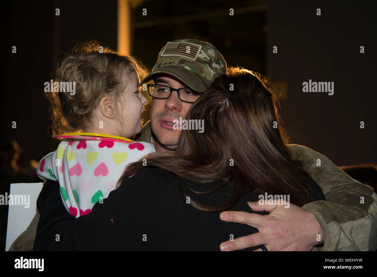Master Sgt. Michael Johnson, 436th Security Forces Squadron defender, embraces his daughter, Amelia, and wife, Kelly, upon his return home from deployment Jan. 21, 2018, at Dover Air Force Base, Del. Johnson’s team was deployed to the Middle East for six months. (U.S. Air Force Stock Photo