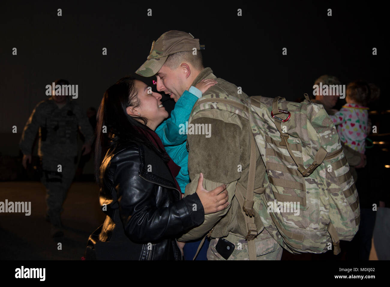 Staff Sgt. Justin Stevenson, 436th Security Forces Squadron defender, kisses his wife, Jamielee, while hugging his daughter, Julia, upon his return home from deployment to the Middle East Jan. 21, 2018, at Dover Air Force Base, Del. Stevenson’s team has been deployed since July 2017. (U.S. Air Force Stock Photo