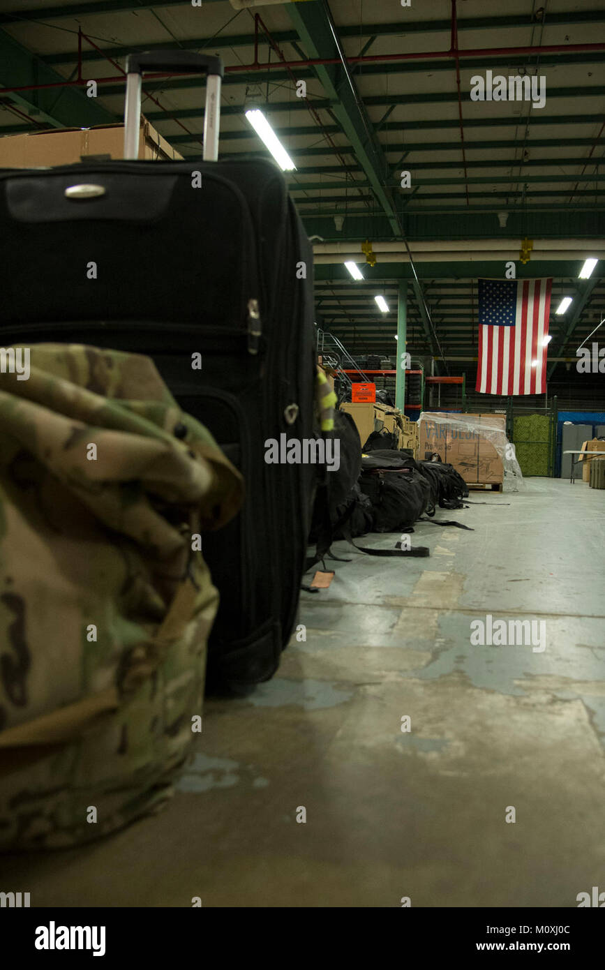 Luggage belonging to 12 returning 436th Security Forces Squadron defenders rests in a warehouse after a six-month deployment to the Middle East, Jan. 21, 2018, at Dover Air Force Base, Del. Families and unit members met the defenders upon their return. (U.S. Air Force Stock Photo