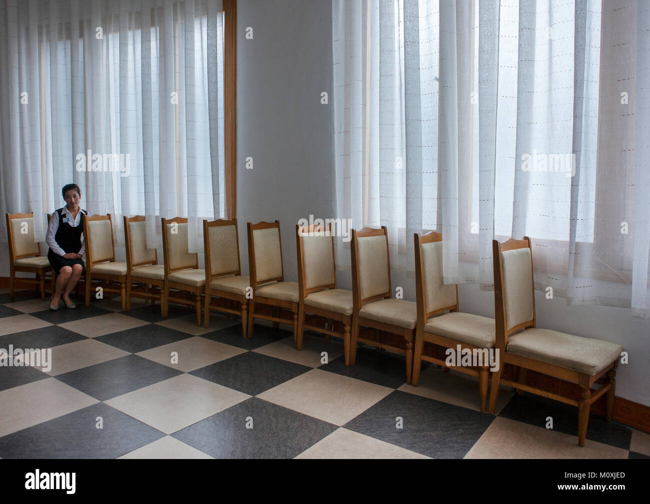 North Korean Waitress Sit On A Chair In Majon Beachfront Holiday