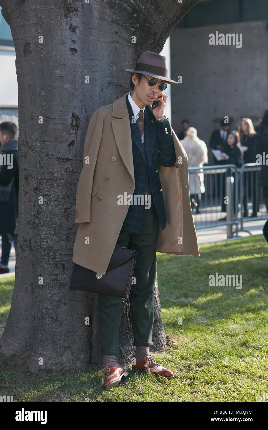 MILAN - JANUARY 13: Man with brown trench coat and hat before Emporio  Armani fashion show, Milan Fashion Week street style on January 13, 2018 in  Mila Stock Photo - Alamy