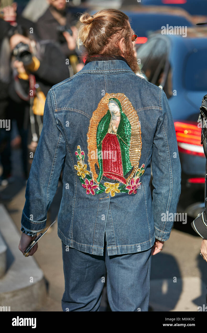MILAN - JANUARY 13: Man with Holy Mary sequin design on blue jeans jacket  back before Emporio Armani fashion show, Milan Fashion Week street style on  Stock Photo - Alamy