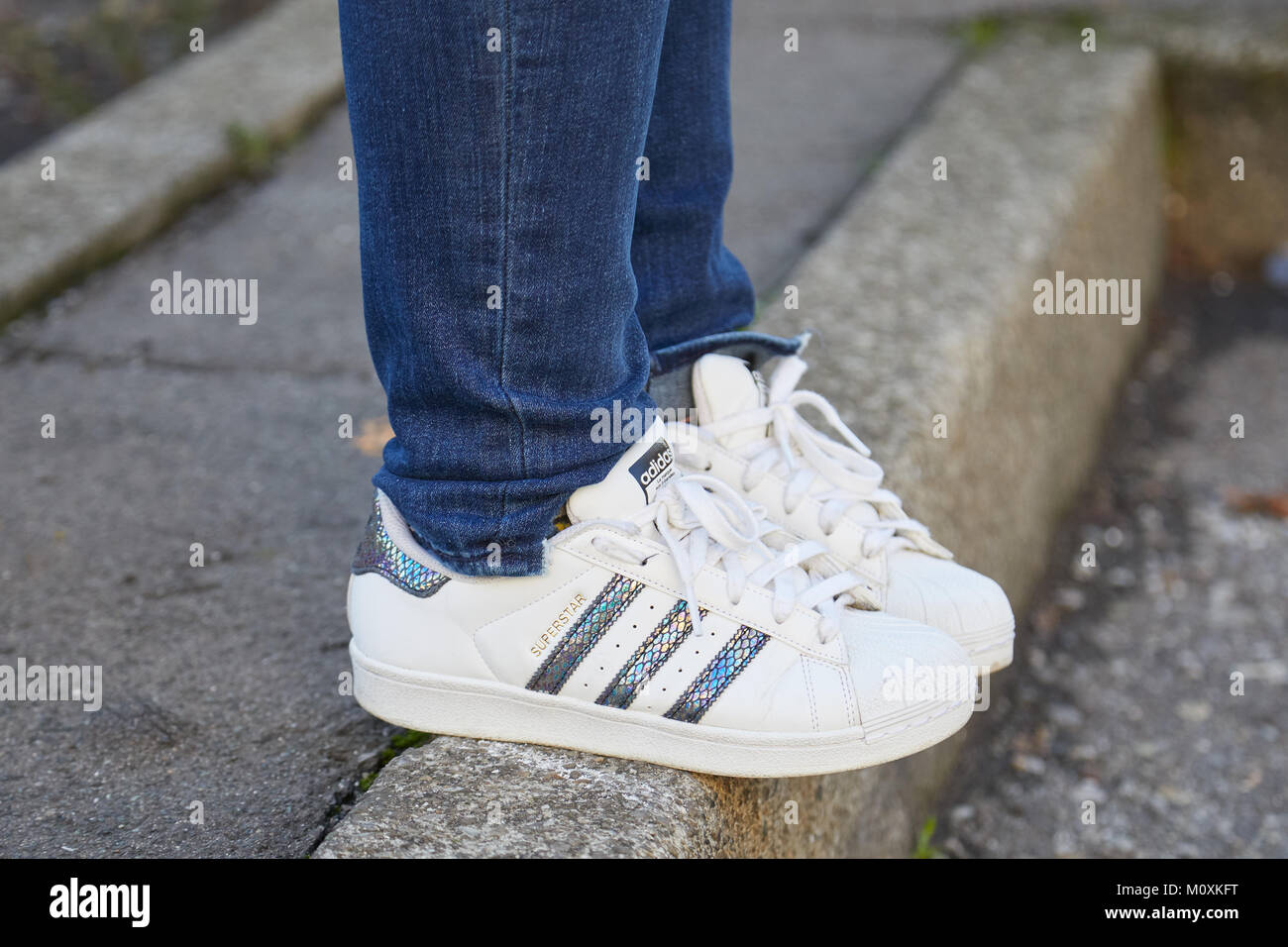 Woman with white leather Adidas shoes 