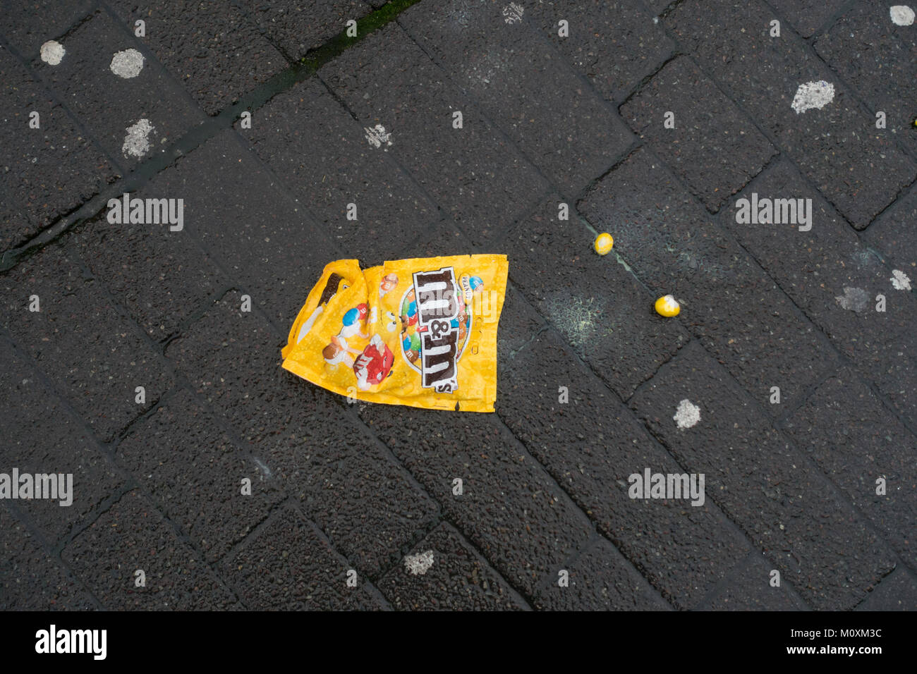 A bag of sweets lies on the pavement Stock Photo